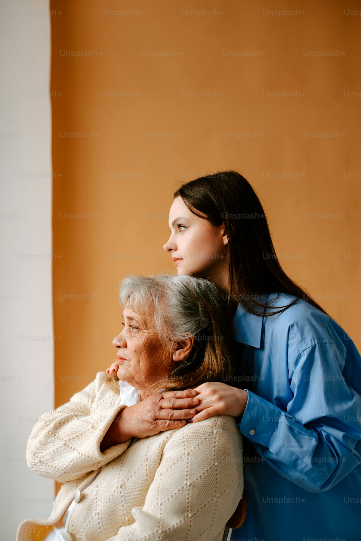 Caregiver holding a client's hand, providing reassurance